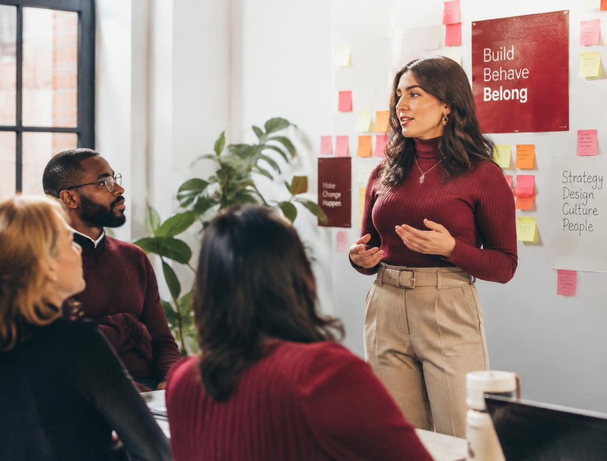 A woman leads a workshop discussion with colleagues